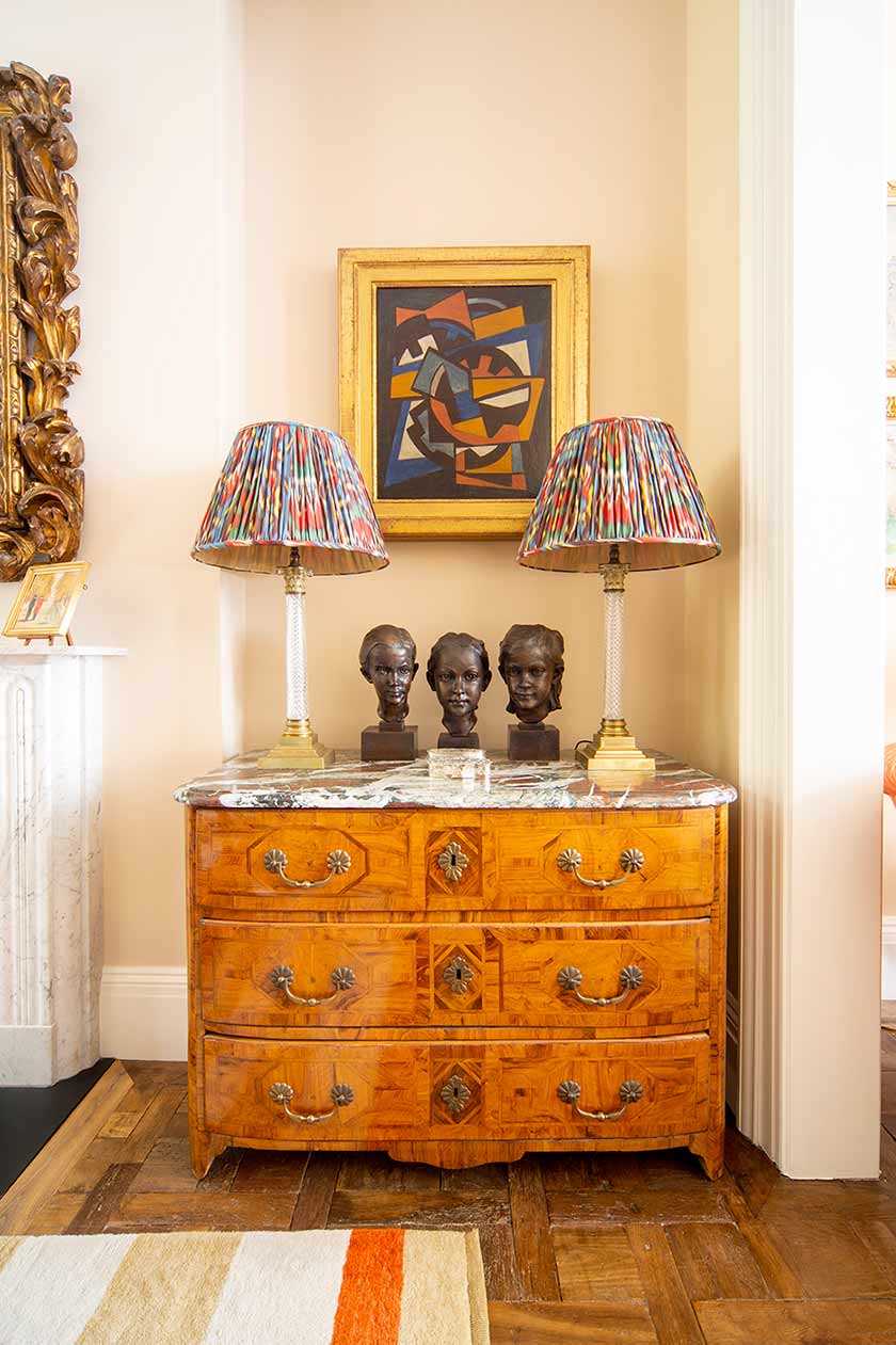 rustic chest of drawers with bust ornaments and lamps