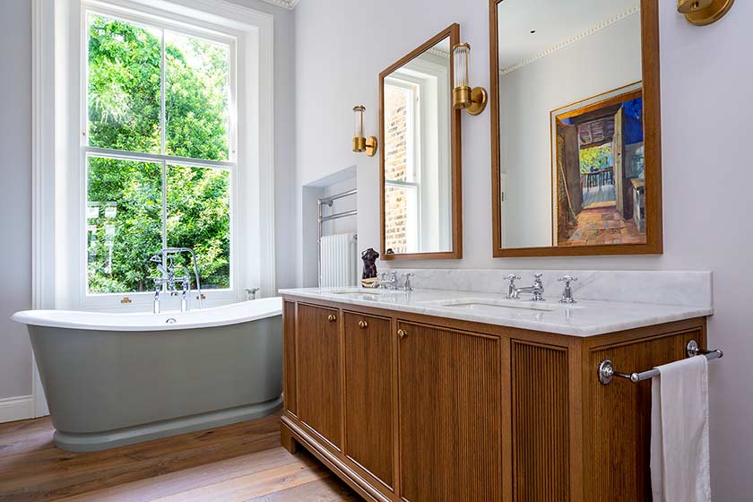 bathroom with wooden cupboards and bathtub