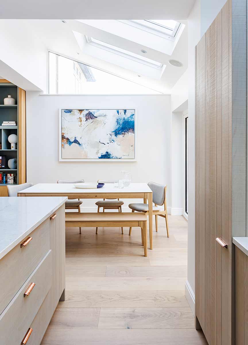 White dining room with wooden floor