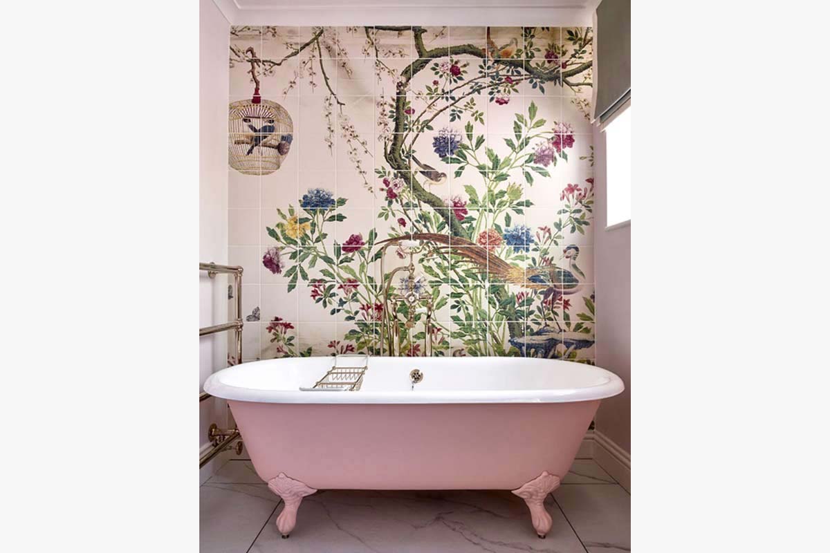 Pink bathtub with ornate painted tiles