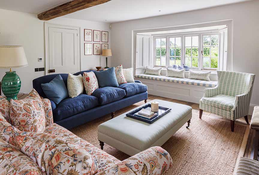 blue sofa, ottoman and window