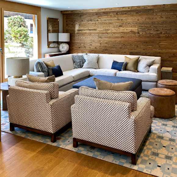 Lounge area with blue and beige decor and wood panelling